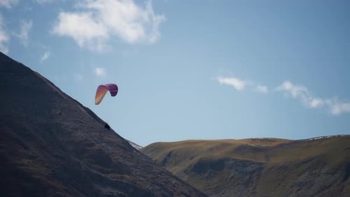 Paragliding next to the mountain slope
