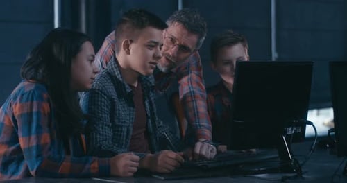 Teens Working Together on Computer in Lab