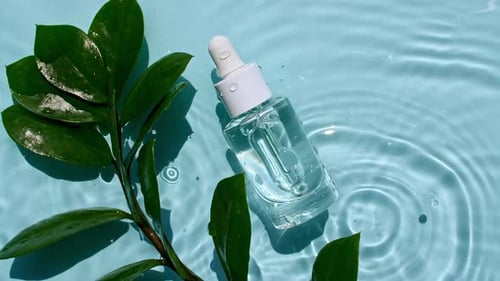 Serum Bottle and Green Plant in Water