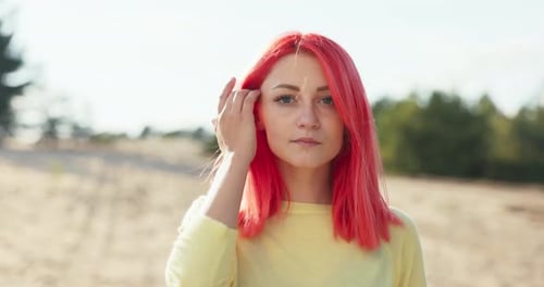 Woman with Red Hair Posing Outdoors