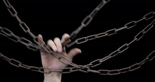 A Man's Hand Drops The Chains