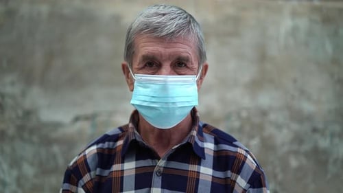 Senior Man Wearing a Surgical Mask Close Up