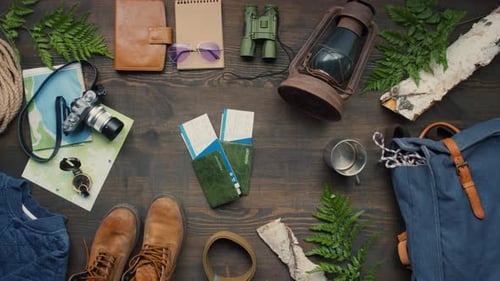 Top View of Travel Accessories and Passports with Tickets on Table