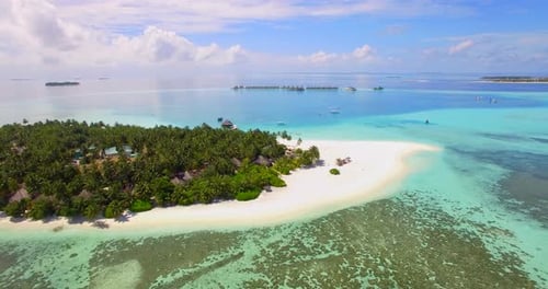 Aerial drone view of a scenic tropical island resort hotel in the Maldives