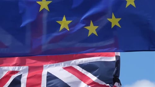 Fluttering EU and UK Flags on a Bright Day