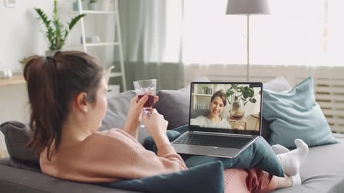 Two Women Connecting Via Laptop From Their Homes