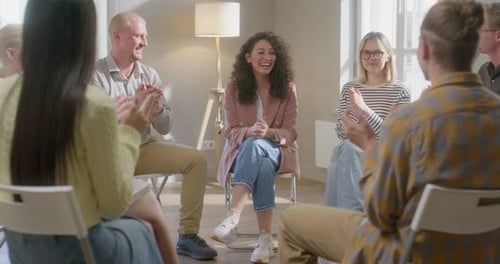 Adults Clapping During an Indoor Meeting
