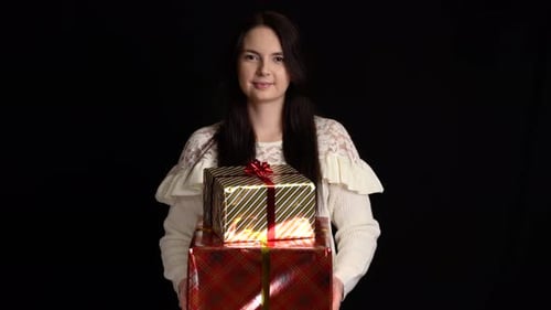 Woman Holds Christmas Gifts in Studio Setting
