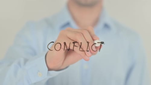 Adult Writes the Word "Conflict" on Glass