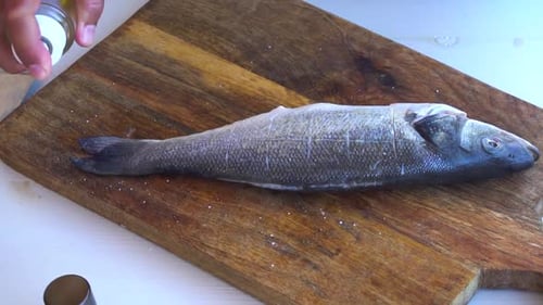 Fresh Sea Fish Preparation Someone Hands Preparing Raw Seabasson Cutting Board Close Up
