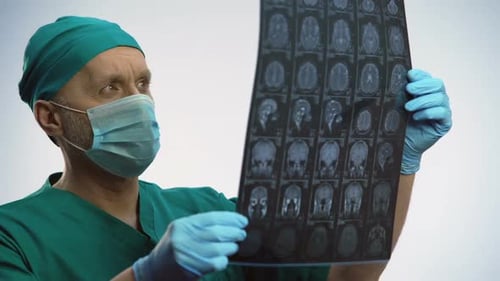 Doctor Reviews Brain Scan in Hospital Setting