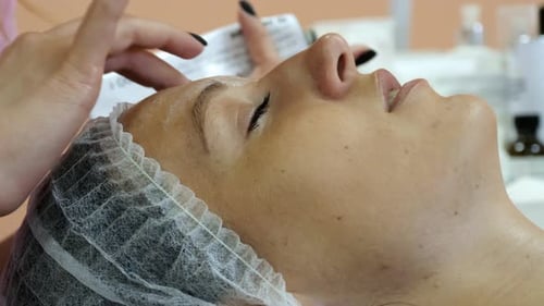 Woman Receiving Relaxing Facial Massage in Salon