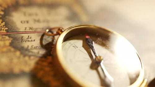 Golden Compass Opens to Reveal Needle on Ancient Map