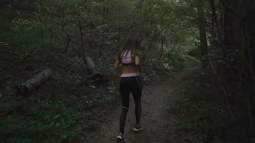 Sports Brunette Girl Trail Running in the Woods, Slow Motion Footage