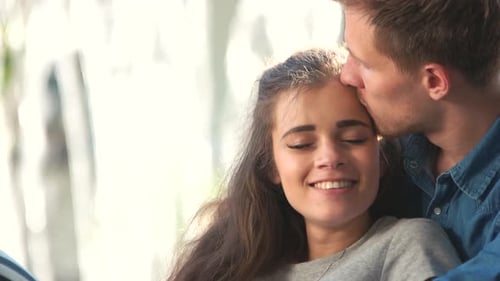 Loving Couple Embracing and Kissing Affectionately