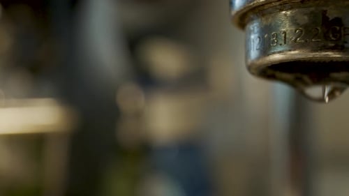 Macro shot of a dripping water faucet - truck right