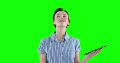 Caucasian woman using a digital tablet on green background