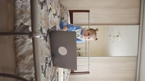 Child Using Laptop in Bedroom at Home