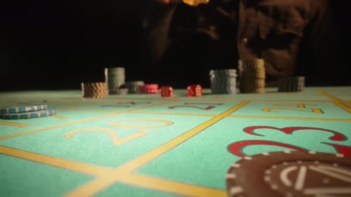 Unrecognizable Male Gambler Sits at a Gaming Table in a Casino