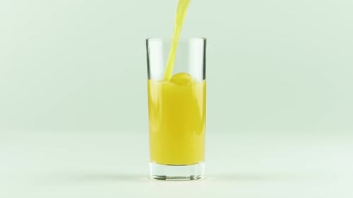 Clear Glass Being Filled With Yellow Juice