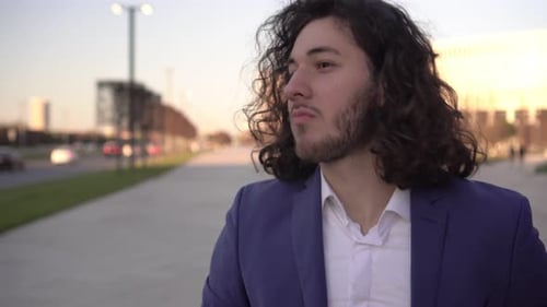 Man Enjoys a Sandwich Outdoors in the City