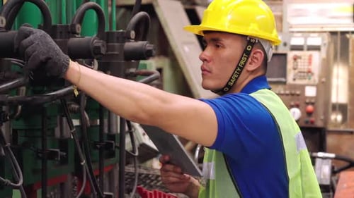 Smart Factory Worker Using Machine in Factory Workshop
