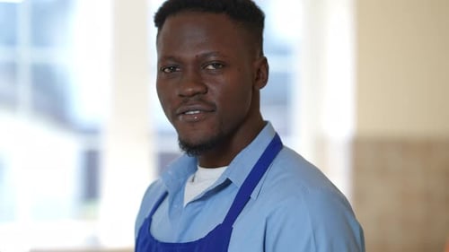 Side View Confident Male African American Chef Hanging Towel on Shoulder Looking at Camera