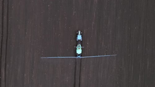 Powerful Agricultural Tractor Apply Mineral and Nitrogen Fertilizer on Ground at Field