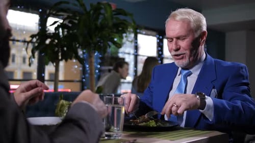 Men Having Business Lunch at Restaurant Table