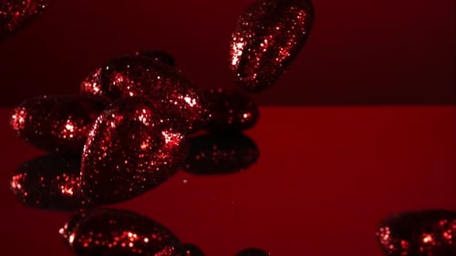Decorations falling, bouncing in ultra slow mo 1500fps - reflective surface - VALENTINES PHANTOM 003