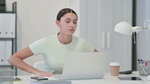 Young Latin Woman Leaving Office After Working on Laptop