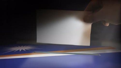 Hand Casting Vote into National Flag Ballot Box