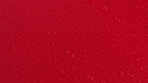 Rotating Red Background with Water Drops Top View