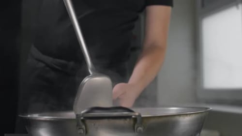 Chef Tosses Fried Vegetables with Noodles in Hot Wok in Slow Motion, Cooking Asian Noodles, Stirring