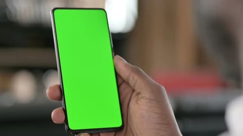 African Man Using Green Chroma Key Smartphone Screen