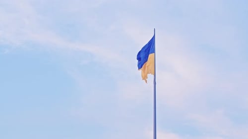 Ukrainian Flag Waving Proudly Against a Light Blue Sky