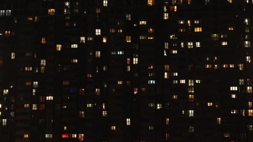 Windows at home. Light in the windows of a multi-story building. Time laps