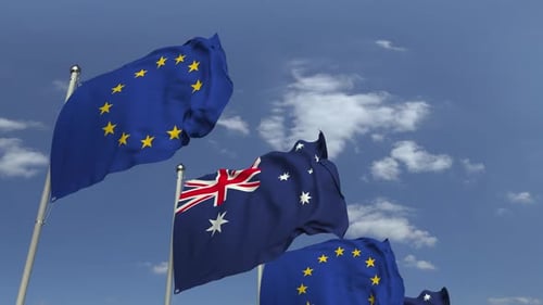 Australia and European Union Flags Waving Against Blue Sky