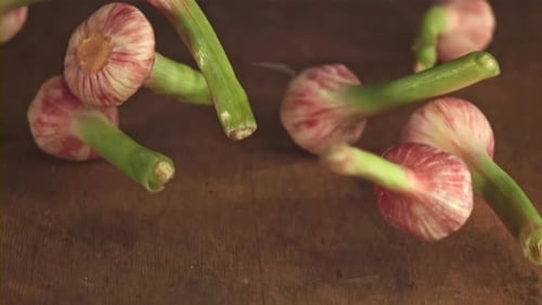 Super Slow Motion Garlic Falls on a Wooden Table