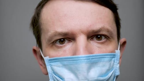 Adult Wearing Medical Mask Against Grey Background