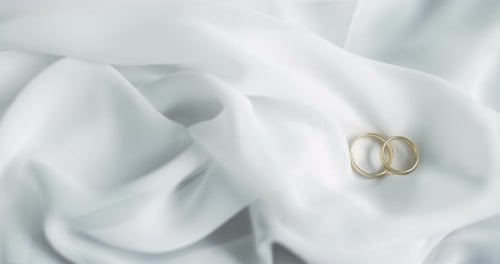 Wedding Rings on White Cloth Symbolize Eternal Love