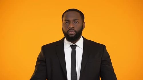 Man in Suit Raises Both Hands