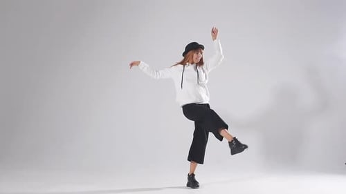 Woman Dancing in Studio with White Background