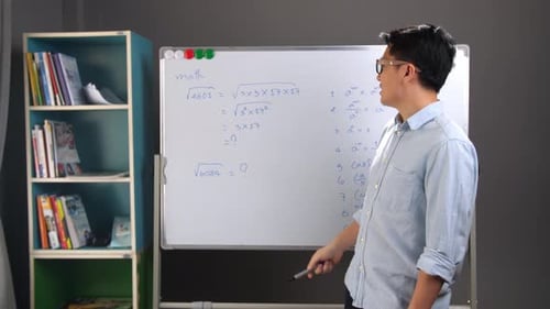 Young Adult Explains Math at Whiteboard