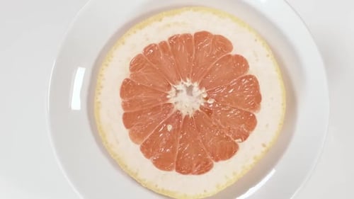 Close-Up of Refreshing Slice of Grapefruit on Plate