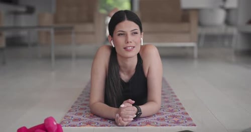 Woman Lying on Yoga Mat Talking on Video Call
