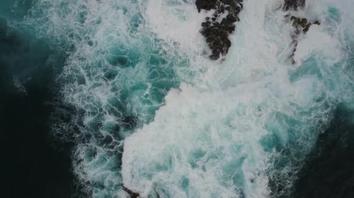 Aerial Top View of Ocean Waves Breaking on Dark Rocks, Canary Islands, Tenerife, Spain