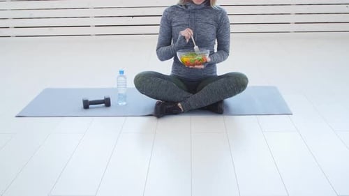 Athletic Woman Eating Salad After Exercise