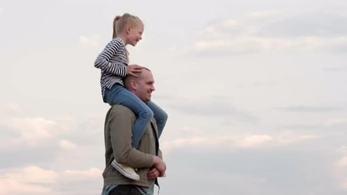 Girl Rides on Father's Shoulders