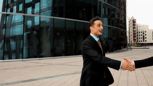Businessmen Shake Hands Outside Modern Office Building
